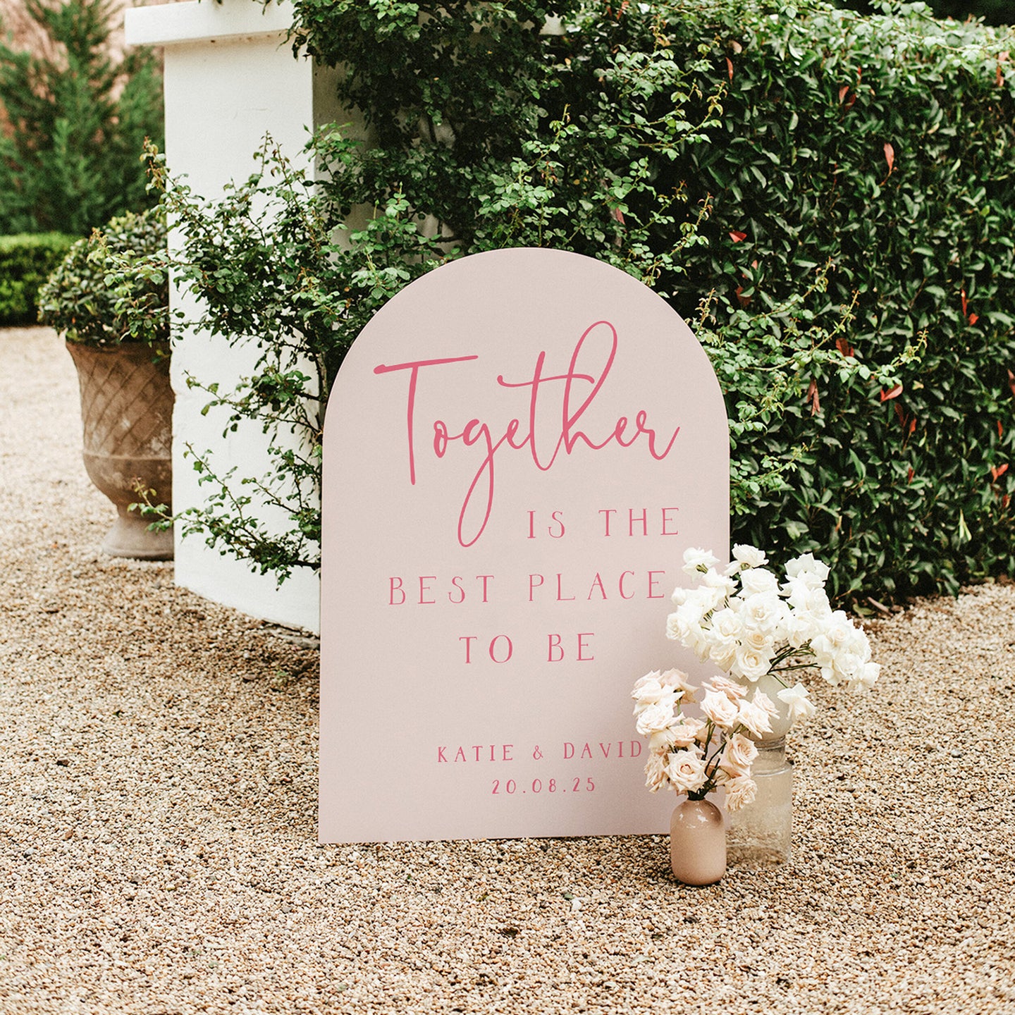 Pink arched wedding sign with quote